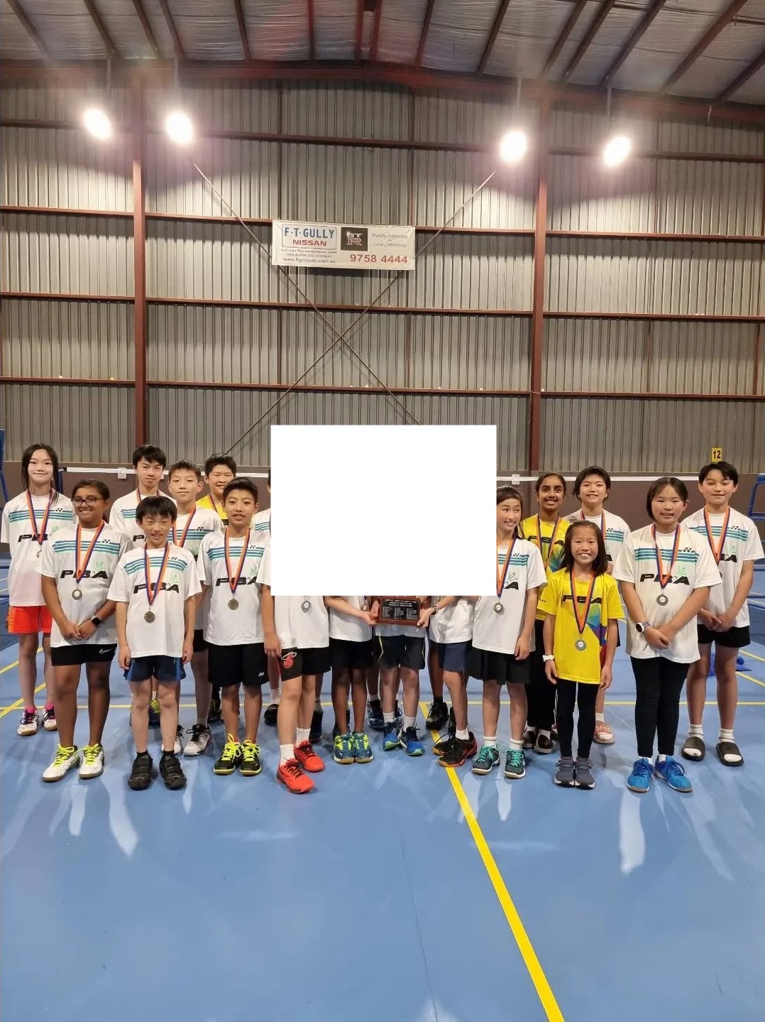 Junior development badminton players with awards